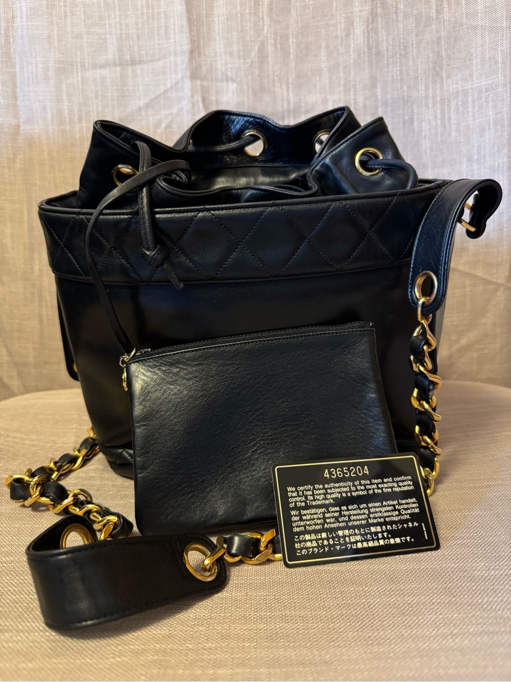 CHANEL Black Quilted Leather Drawstring Crossbody with Gold Chain
